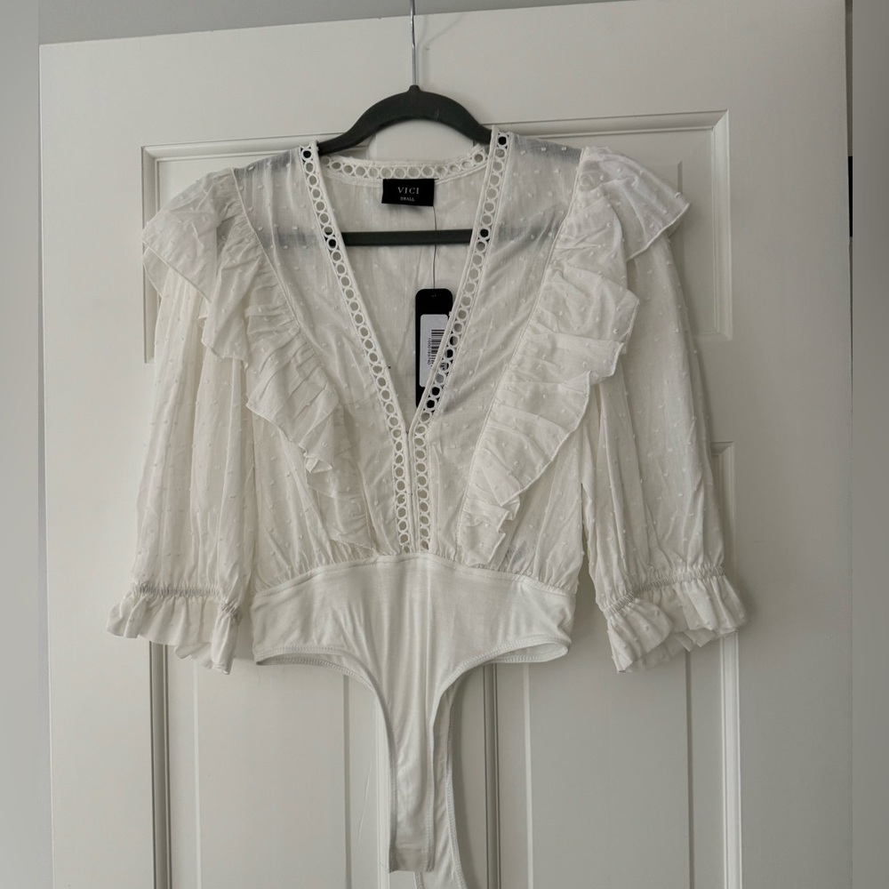 White, mid sleeve bodysuit. Never worn